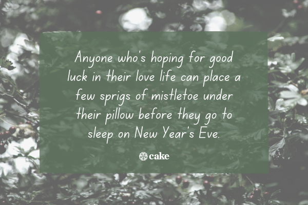 Text about sleeping on mistletoe on new year's eve over an image of mistletoe