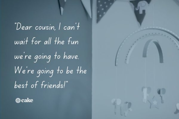 Example of a baby shower book message from cousins over an image of a baby mobile